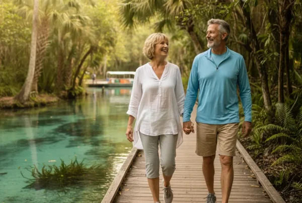 Active older couple walking happily on the boardwalk at Silver Springs State Park.